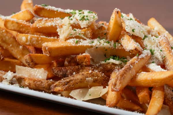 Closeup of a plate of truffle parmesan fries