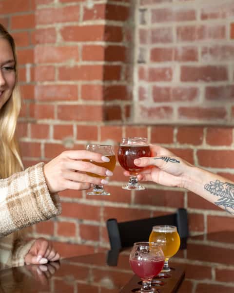 Two women cheering drinks