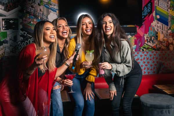 Group of friends enjoying cocktails and nightlife at Kapow! Noodle Bar, capturing the restaurant's energetic atmosphere and elevated social dining experience.