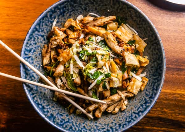 Savory stir-fried Asian noodles with mushrooms, herbs, and umami-rich flavors at Kapow! Noodle Bar, showcasing elevated modern Asian fusion cuisine.