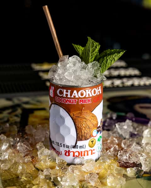 Chaokoh coconut cocktail served over crushed ice with fresh mint at Kapow! Noodle Bar, a modern Asian fusion restaurant in Boca Raton and Delray Beach known for handcrafted cocktails.