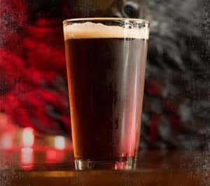 dark amber beer filled pint glass