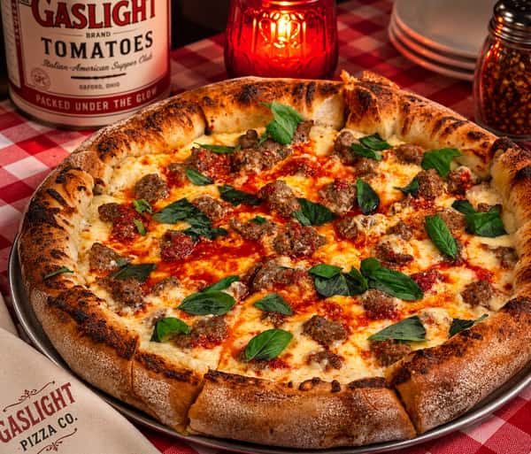 Louis Primo would be proud! Alfredo Base, our three cheese blend, Italian sausage, the secret ingredient and Calabrian chili oil drizzle and finished with fresh basil