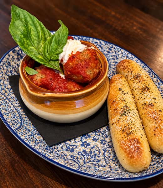 Homemade Parmesan, Italian sausage and beef meatballs in a Brew Homemade sauce. With burrata and hand stretched breadsticks.
