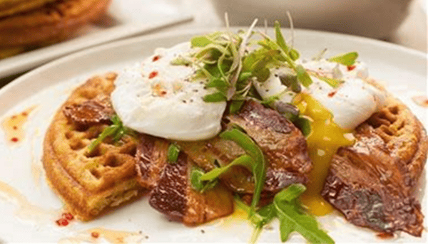 Cornbread Waffle topped w/ Bacon or Sausage and Poached Eggs.