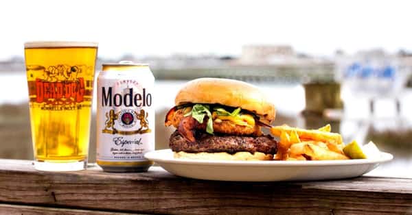 Burger with fries and a Modelo beer and a beer in a Dead Dogs Saloon glass