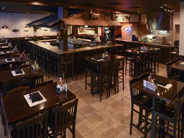 dining room with tables set up and bar