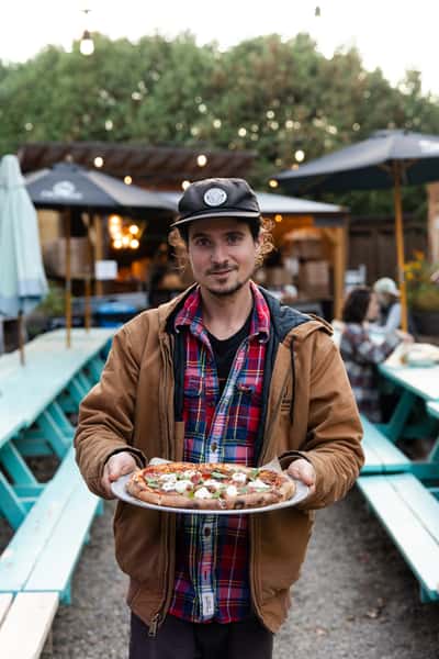 Jon holding fogtown food-fired pizza