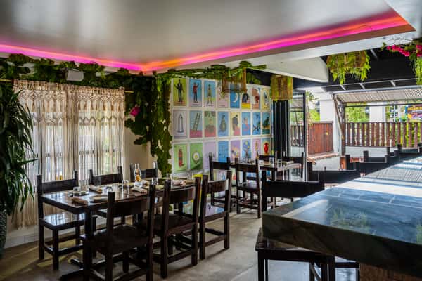 Interior dining highlighted with greenery and fluorescent neon pink