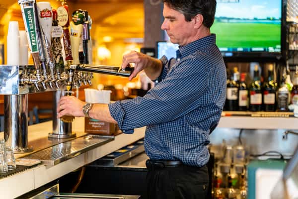 bartender pours beer