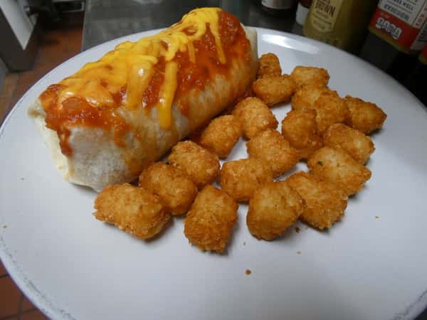 Cheesy smothered breakfast burrito topped with red sauce and melted cheddar, served with a side of crispy golden tater tots.