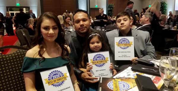 family holding awards