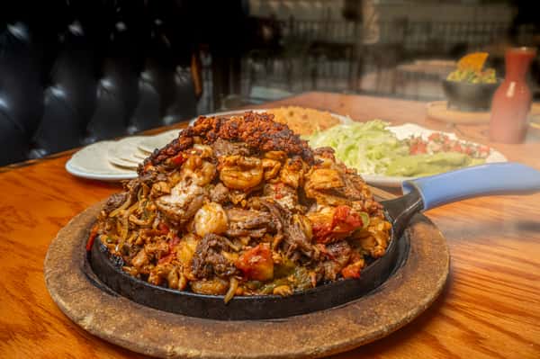 A feast for the family—steak, grilled chicken, shrimp, chorizo, and pork all grilled together and served with eight warm tortillas.