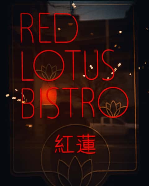Red Neon Sign outside restaurant reading "Red Lotus Bistro"
