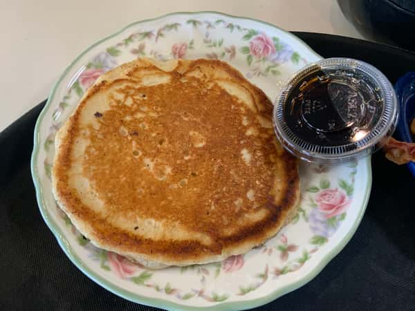 Single Pancake served with syrup and butter