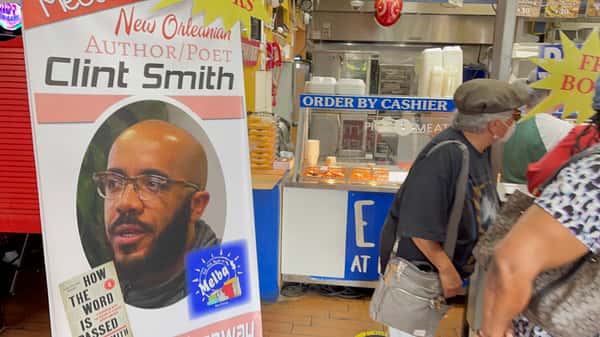 Clint Smith author event sign inside Melba's restaurant near Southern food counter and "Order by Cashier" station
