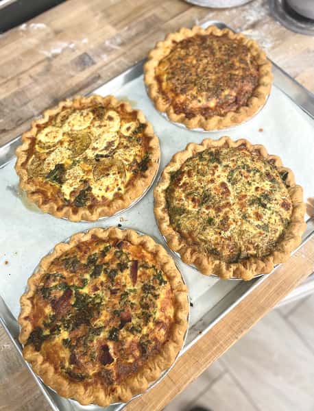 a pan full of freshly baked quiche