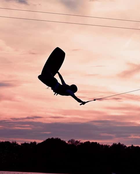 Wake boarding man against a skyline