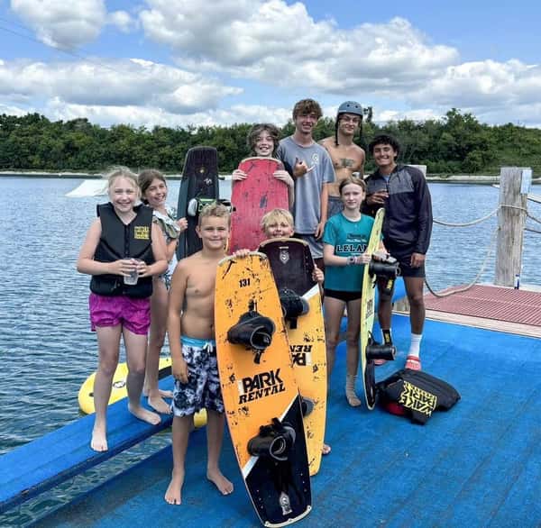 Kids on a dock with a wake board