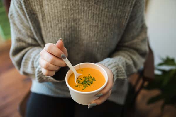 girl holding bowl of soup