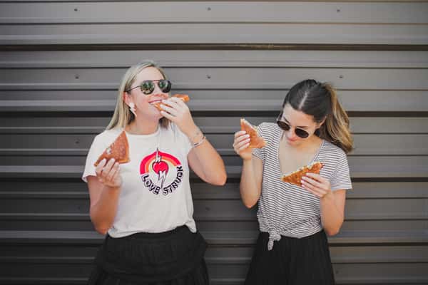 two girls enjoying grilled cheese sandwiches