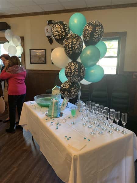 table setup with balloons and champagne glasses