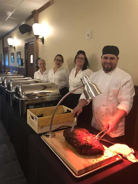 buffet station setup with chefs to help serve and carve meat