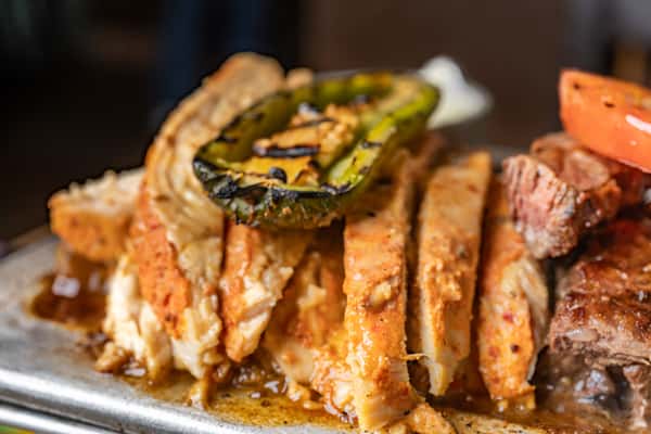 Chicken Fajitas: Sizzling and savory, tender strips of grilled chicken with vibrant peppers and onions, wrapped in warm tortillas
