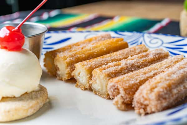 Golden Churros: 6 delectable twists of fried dough, crispy outside, soft inside. Perfectly paired with luscious sauce
