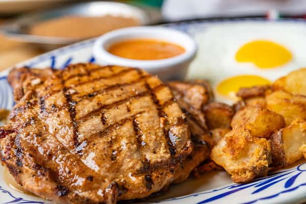 A savory duo of perfectly cooked eggs and juicy pork chops