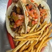 White Fish Tacos served on a bed of chipotle coleslaw and topped with our homemade pico de gallo