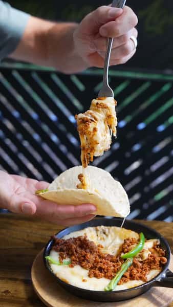 Cheese Pulls & Savory Thrills! 🥳

Is there anything better than a sizzling skillet of Queso Fundido? We're talking ooey-gooey, bubbly melted cheese generously loaded with perfectly spiced, savory chorizo. It's rich, comforting, and an absolute must-have for the table. 🤤

Scoop up the magic your favorite way! Served hot and fresh with your choice of:

Crispy corn chips for that perfect crunch

Warm flour tortillas for a soft, pillowy bite

Toasted corn tortillas to keep it authentic and
classic. 😋🎉