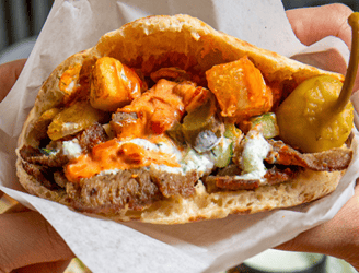 Pita Sandwich w/Gyro Meat, Fries, Harissa Mayo, Harissa Ketchup, Tzatziki, and Pickles
