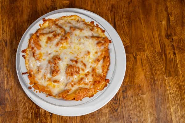 Cheese lasagna baked with layers of pasta, tomato sauce, and melted mozzarella, served hot on a round plate.