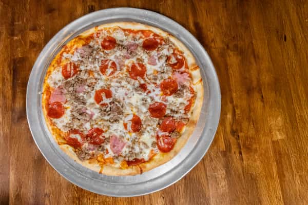 Hand-tossed meat lover's pizza topped with pepperoni, sausage, ham, and mozzarella cheese, served on a silver tray over a wooden table.