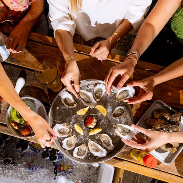 Large group of friends enjoying a oyster platter