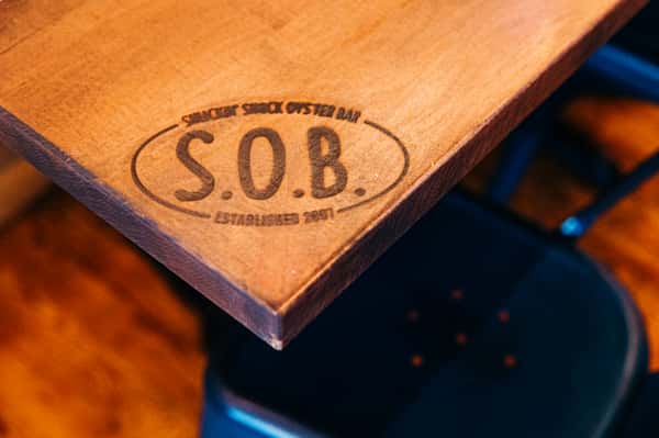 Shuckin' Shack Oyster Bar wood table engraving decal