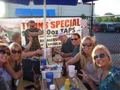 People sitting at an outdoor table for a group photo