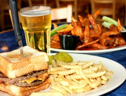 Double cheese burger in sandwich bread with French fries and wings