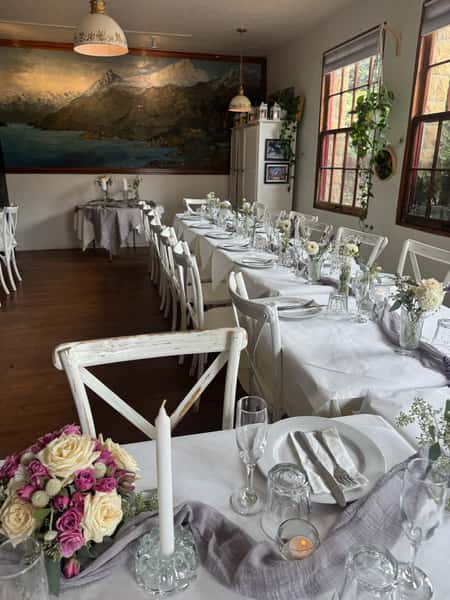 tables with white tablecloths set for an event