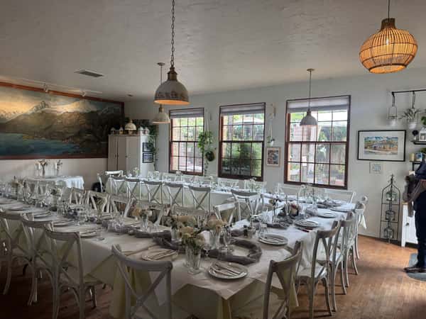 beautiful tables in the Lake Como Room with white tablecloths set for an event