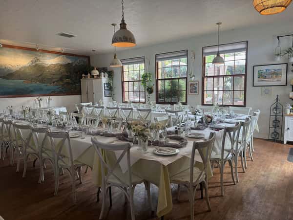 beautiful tables with white tablecloths set for an event