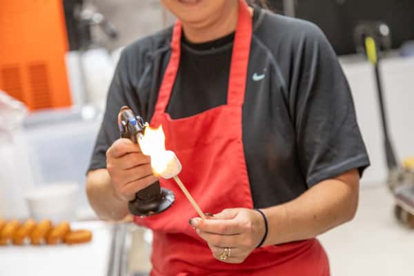 staff member roasting marshmallow