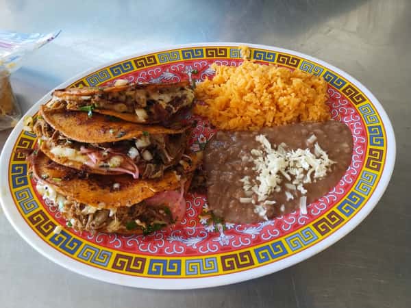 Crispy birria tacos stuffed with shredded beef, served with Mexican rice and refried beans topped with cheese on a colorful plate.
