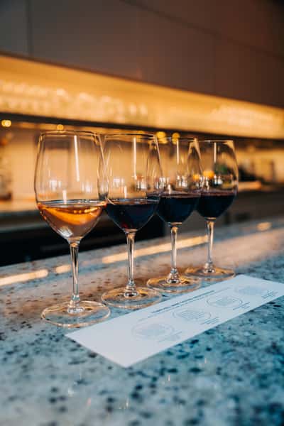 Photo of wine glasses lined up with a tasting mat on the Town Hall bar.