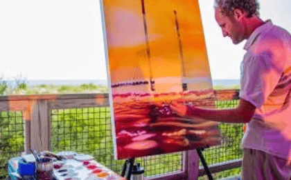 Man painting a scenic landscape on a canvas