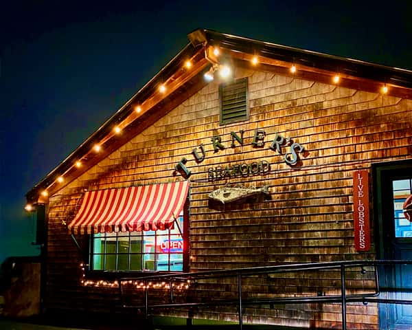 Gloucester store front at night with lights