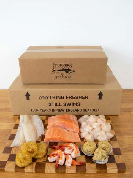 Fresh seafood and prepared items on a display board in front of packaging for D2D