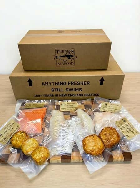 Vaccum sealed seafood and prepared items on a display board in front of packaging or D2D