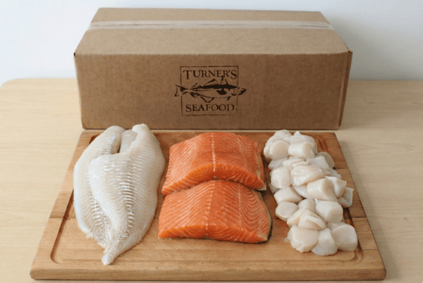 Fresh seafood on a cutting board in front of one box for D2D